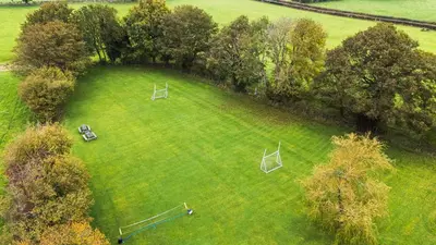 an aerial view of a large grassy field with trees at Bwthyn Ty Newydd in Pont Dolanog