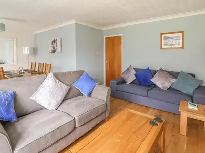 a living room with two couches and a table at Trederwen in Rhayader