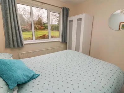 a bedroom with a bed and a window at Trederwen in Rhayader