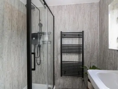 a bathroom with a shower and a sink at Red Kite Cottage in Llandrindod Wells