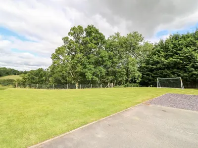 a soccer field with a goal in the grass at Red Kite Cottage in Llandrindod Wells