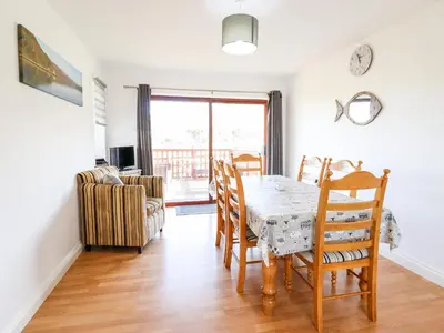 a dining room with a table and chairs at Sealyons in Fairbourne