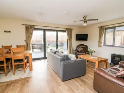 a living room with a couch and a table at Caban Nant Ddu in Nantmel