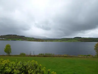 a view of a lake on a cloudy day at Ffynnon Gower in Llangower