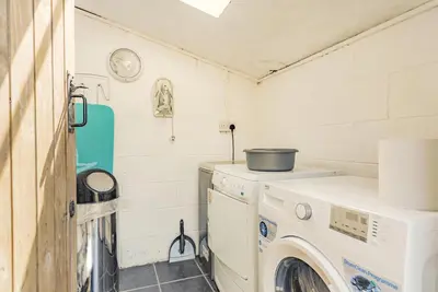 a laundry room with a washer and dryer at Y Becws in Llanbedr