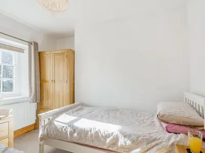 a small bedroom with a bed and a window at Bro Dawel in Dolgellau