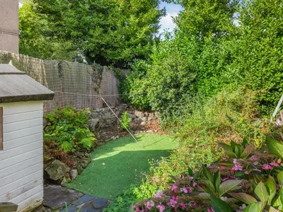 a garden with green grass and a fence at Bro Dawel in Dolgellau