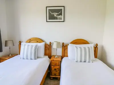 two beds sitting next to each other in a bedroom at Foxes Meadow in Llandrindod Wells