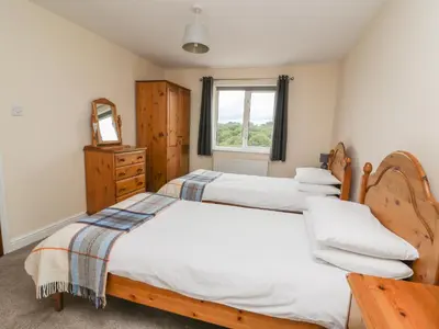 a bedroom with two beds and a window at Pheasant Wood in Llandrindod Wells