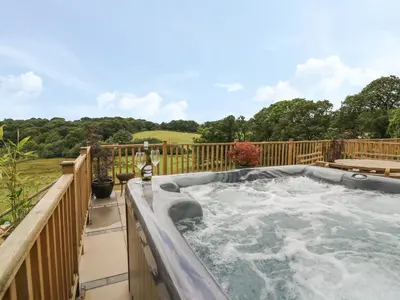 a hot tub on the deck of a house at Pheasant Wood in Llandrindod Wells