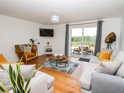 a living room with two couches and a table at Pheasant Wood in Llandrindod Wells