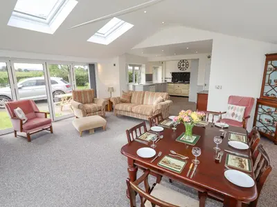 a living room with a table and chairs at Bryn Caer in Chirbury