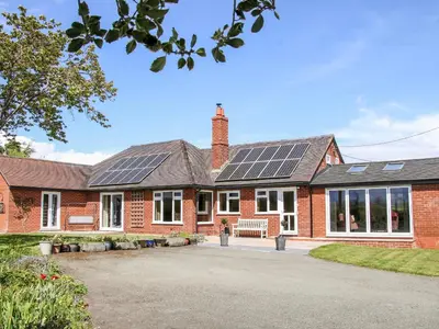 a house with solar panels on the roof at Bryn Caer in Chirbury