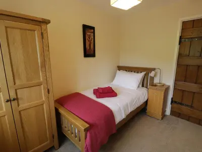a bedroom with a bed with a red towel on it at Hafan in Llanerfyl