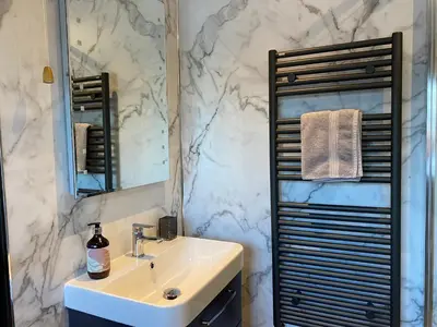 a bathroom with a sink and a mirror at Hafan in Llanerfyl
