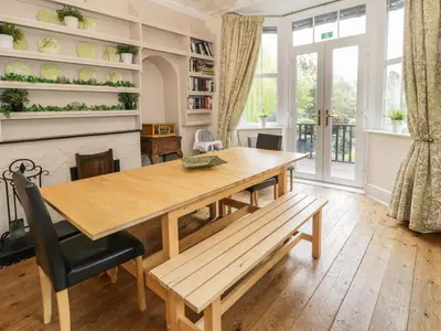 a dining room with a wooden table and a bench at The Mill House in Carrog
