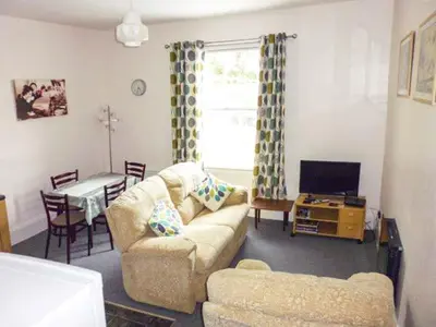a living room with a couch and a table at Harley Apartment in Bishops Castle