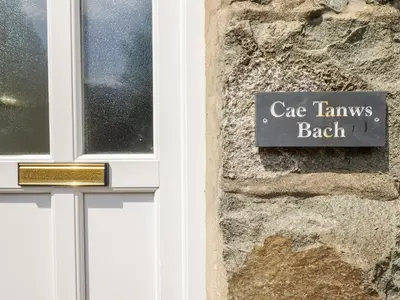 a sign on a building that reads case tawnes beach at Cae Tanws Bach in Dolgellau