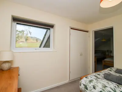 a bedroom with a window and a bed at Bicton Lea in Acton