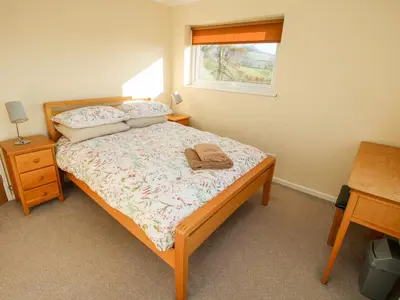 a bedroom with a bed and a window at Bicton Lea in Acton