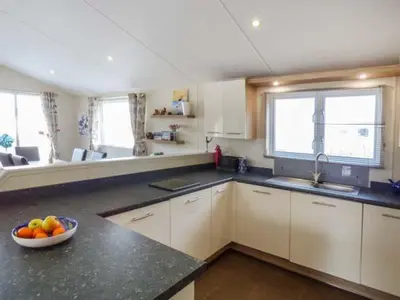 a kitchen with a bowl of fruit on a counter at Clearview Lodge in Borth
