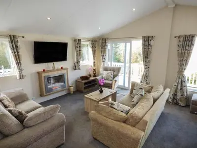 a living room with two couches and a tv at Clearview Lodge in Borth
