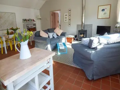 a living room with two couches and a table at Goosepond in Wistanstow