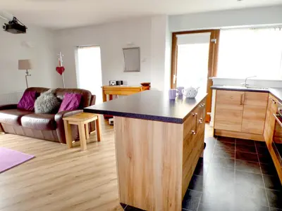 a kitchen and living room with a large island in the middle at Penylodge in Builth Wells