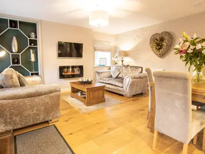 a living room with a couch and a table at Moelfre Cottage in Llanbedr