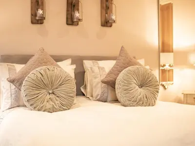 a white bed with pillows on top of it at Moelfre Cottage in Llanbedr