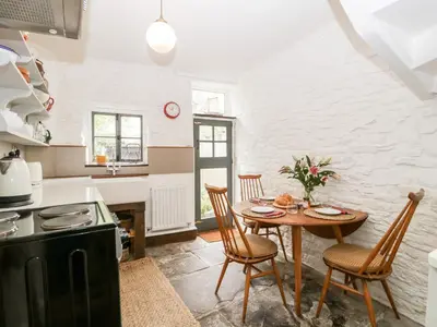 a kitchen and dining room with a table and chairs at 7 Bell Street in Talgarth