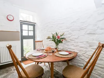 a dining room with a wooden table and chairs at 7 Bell Street in Talgarth