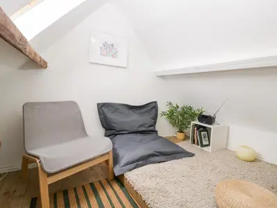 a room with a bed and a chair in it at 7 Bell Street in Talgarth