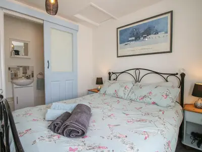 a bedroom with a bed with towels on it at The Old Beams at Pont y Forwyn in Llansantffraid-ym-Mechain