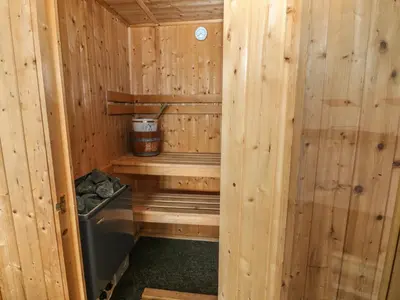 a wooden cabin with a stove in it at Awel Y Llan in Llanfair