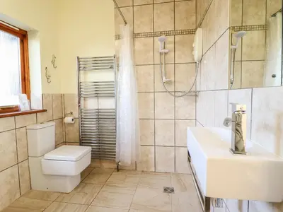 a bathroom with a toilet and a sink and a shower at Dehangfa in Fairbourne