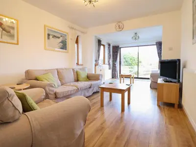 a living room with a couch and a tv at Dehangfa in Fairbourne