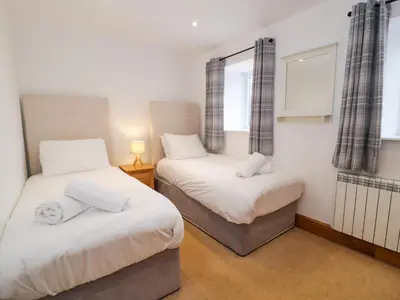 a bedroom with two beds and a window at Cornel Glyd in Dyffryn
