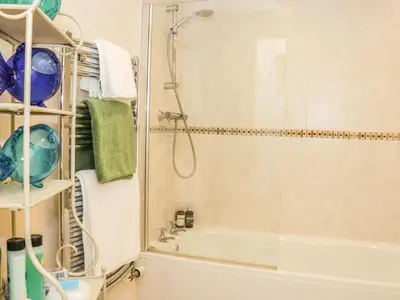 a bathroom with a shower and a tub at Clun Forest Cottage in Monkhopton