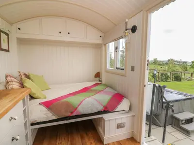 a small bed in a small room with a window at Shepherd's View in Saint Harmon