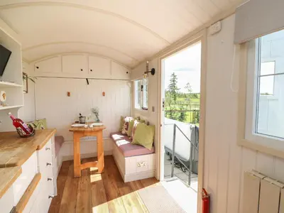 a tiny house with a kitchen and a balcony at Shepherd's View in Saint Harmon