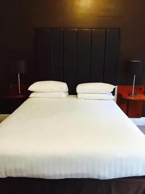 a large white bed with two pillows on it at The Vaults in Shrewsbury