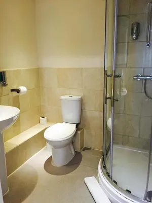 a bathroom with a toilet and a shower and a sink at The Vaults in Shrewsbury