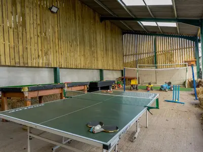 a ping pong table in a large room with a ping pong ball at The Old Dairy in Shrewsbury