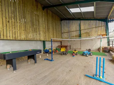 a room with a ping pong table and some toys at The Granary in Shrewsbury
