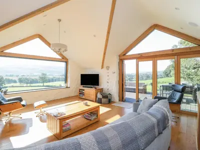 a living room with a couch and a table at Tyn Llwyn in Gwyddelwern