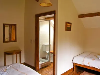 a bedroom with a bed and a sliding glass door at Tailor's Cottage in Abbey-Cwmhir
