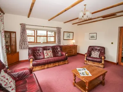 a living room with leather couches and a coffee table at The Stable in Craven Arms