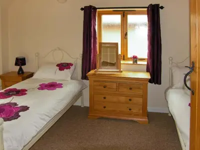 a bedroom with a bed and a dresser with a mirror at The Old Cider Mill in Farden