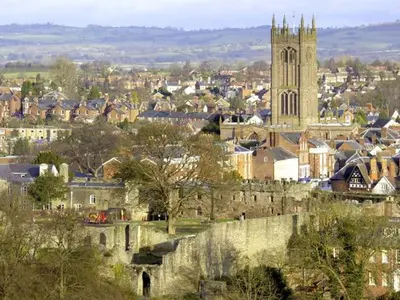 a city with a castle and a church tower at The Old Cider Mill in Farden